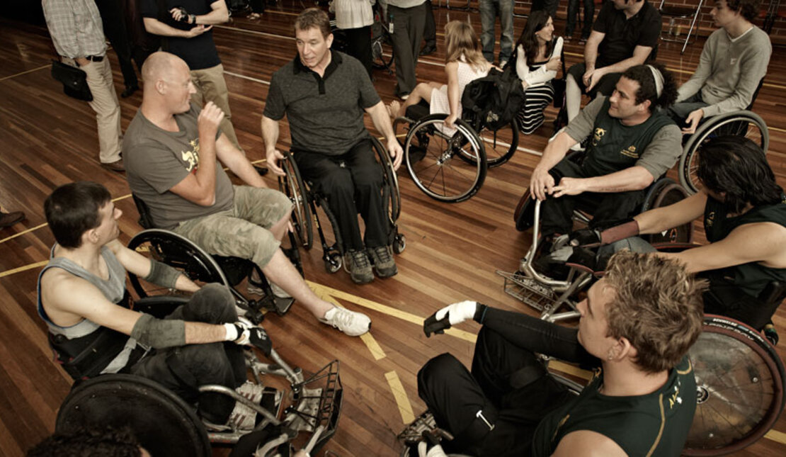 Rick and group of people talking in wheelchairs