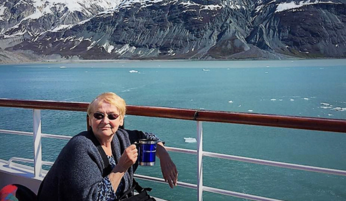 Photo of Margaret Saloustros with water and mountains in the background