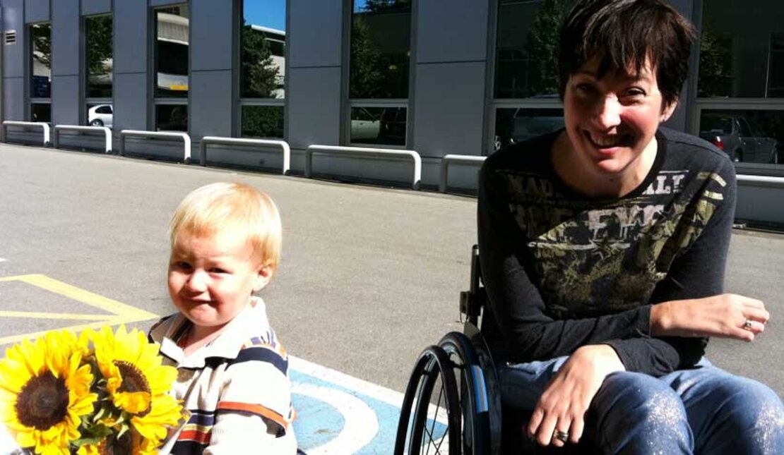 Young boy holding sunflowers with RHF Ambassador, Teri Thorson