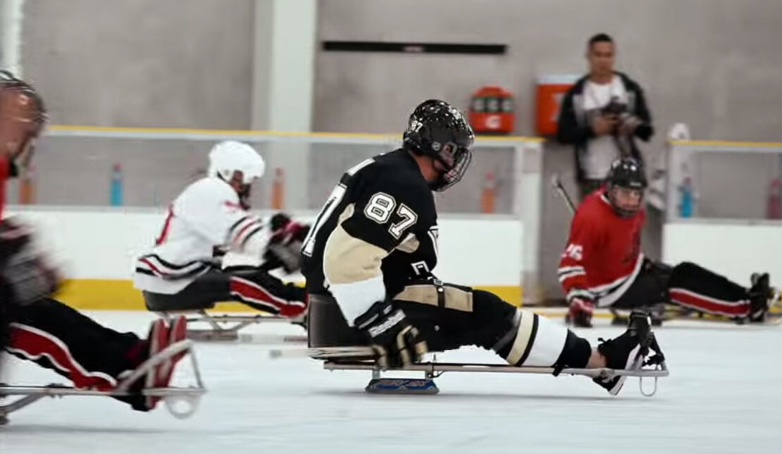 People with disabilities playing a game of ice hockey