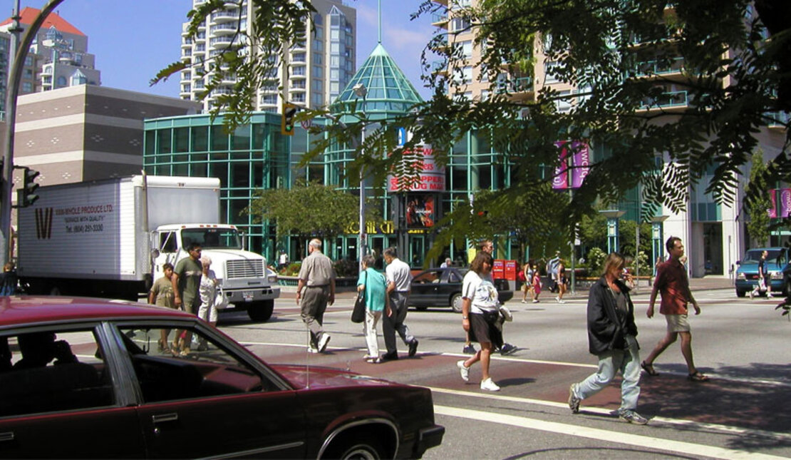 People crossing crosswalk in New Westminster on a sunny day