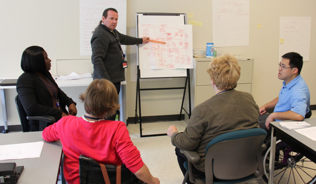 Instructor teaching individuals how to communicate effectively with people with hearing loss