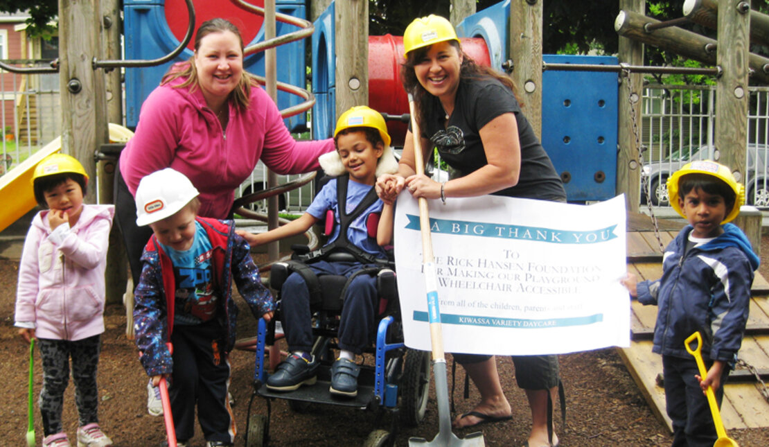 Teachers and students in an accessible playground
