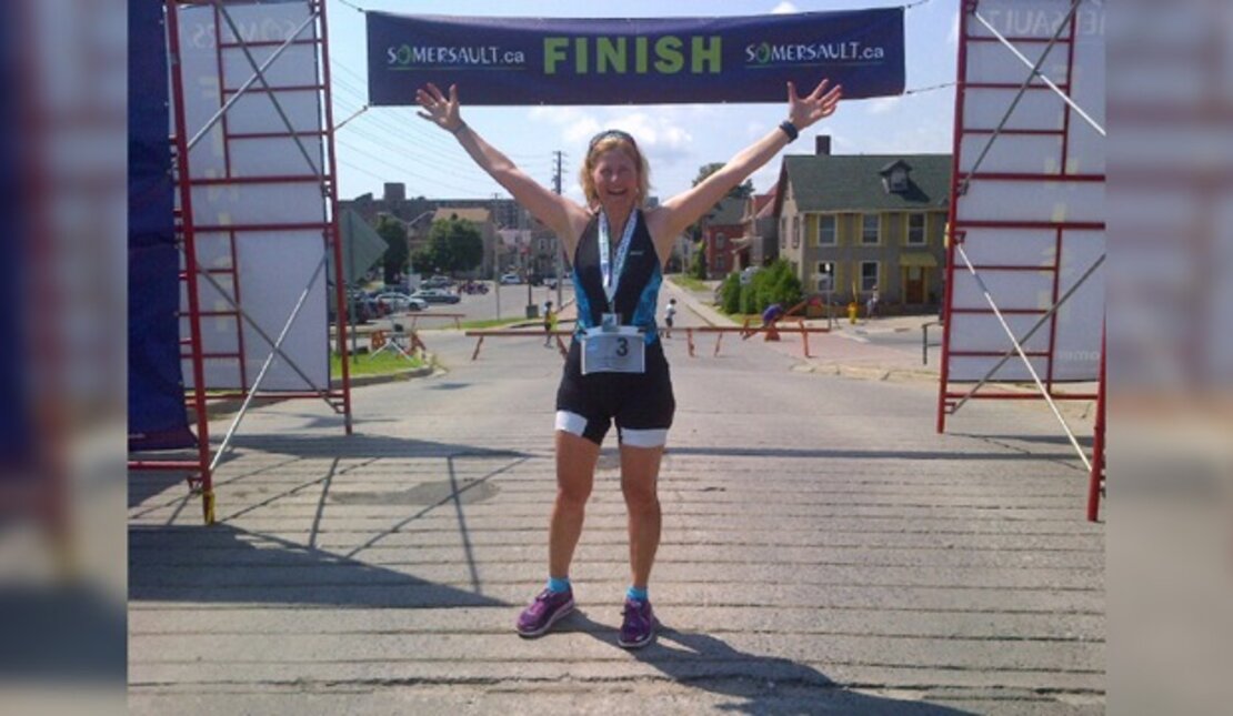 Women raises arms as she finishes race with Somersault.ca