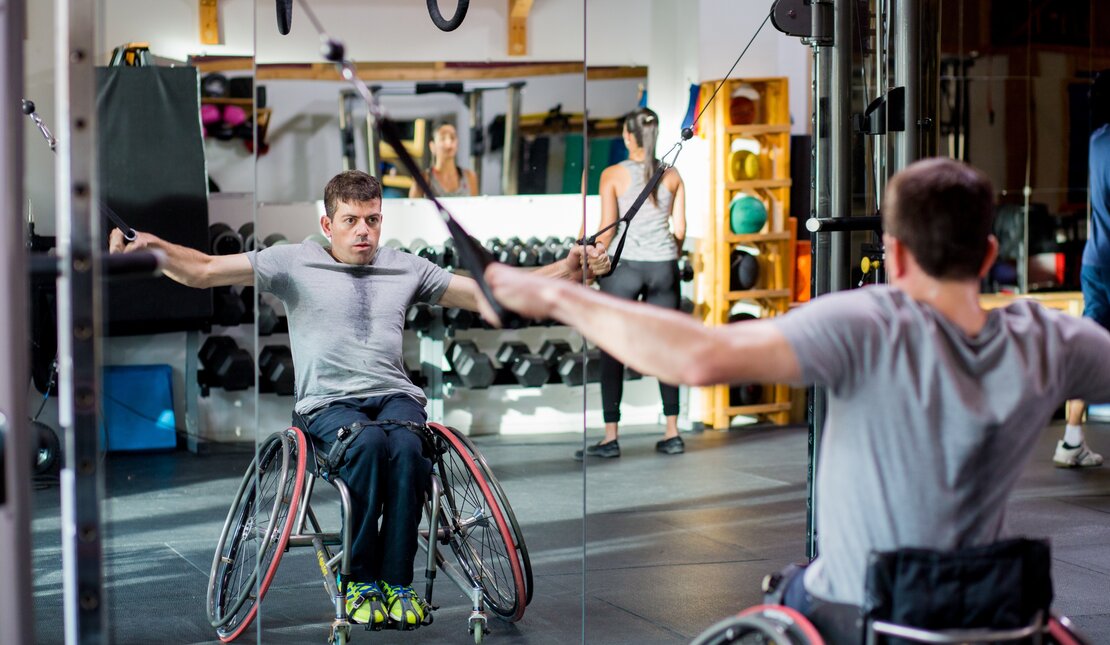 Joel Dembe vigorously exercises at a gym