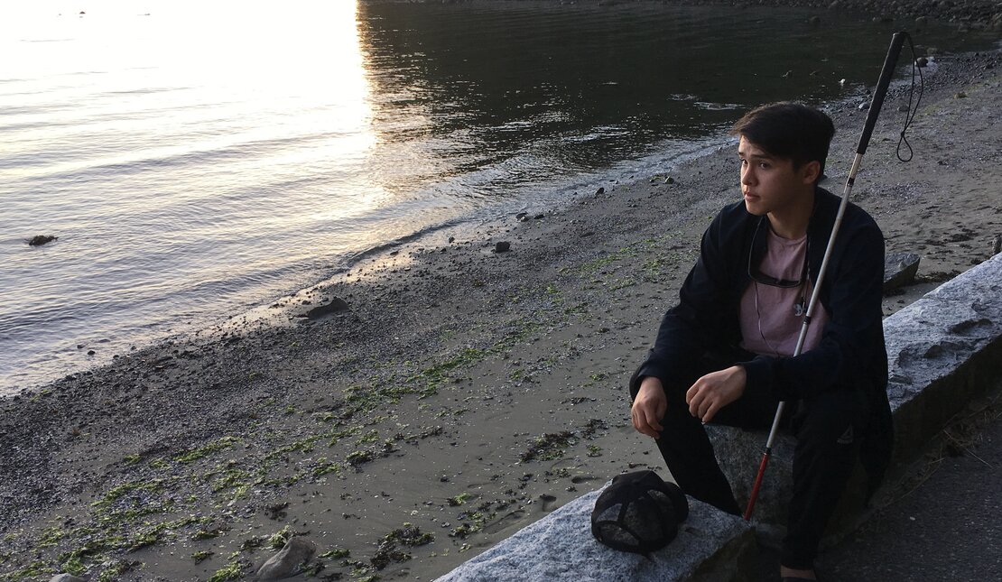 Ben at beach with cane at sunset