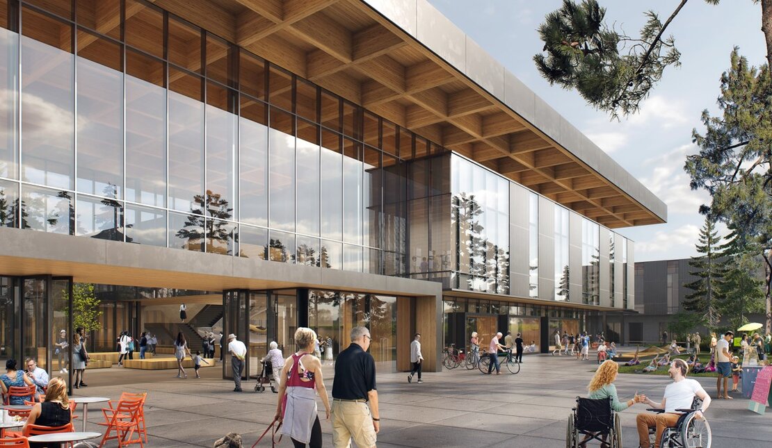 Artist's Rendering of the front entrance of the new Harry Jerome Community Recreation Centre (HJCRC). Lots of people walking, talking, strolling in the plaza including people with dogs, on bikes and n wheelchairs.