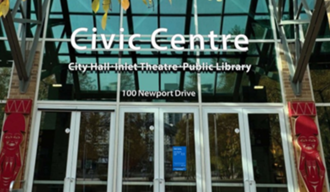 Glass entrance of the Civic Centre with large white text on the facade reading: “Civic Centre." Two red carved figures are positioned on either side of the doors.