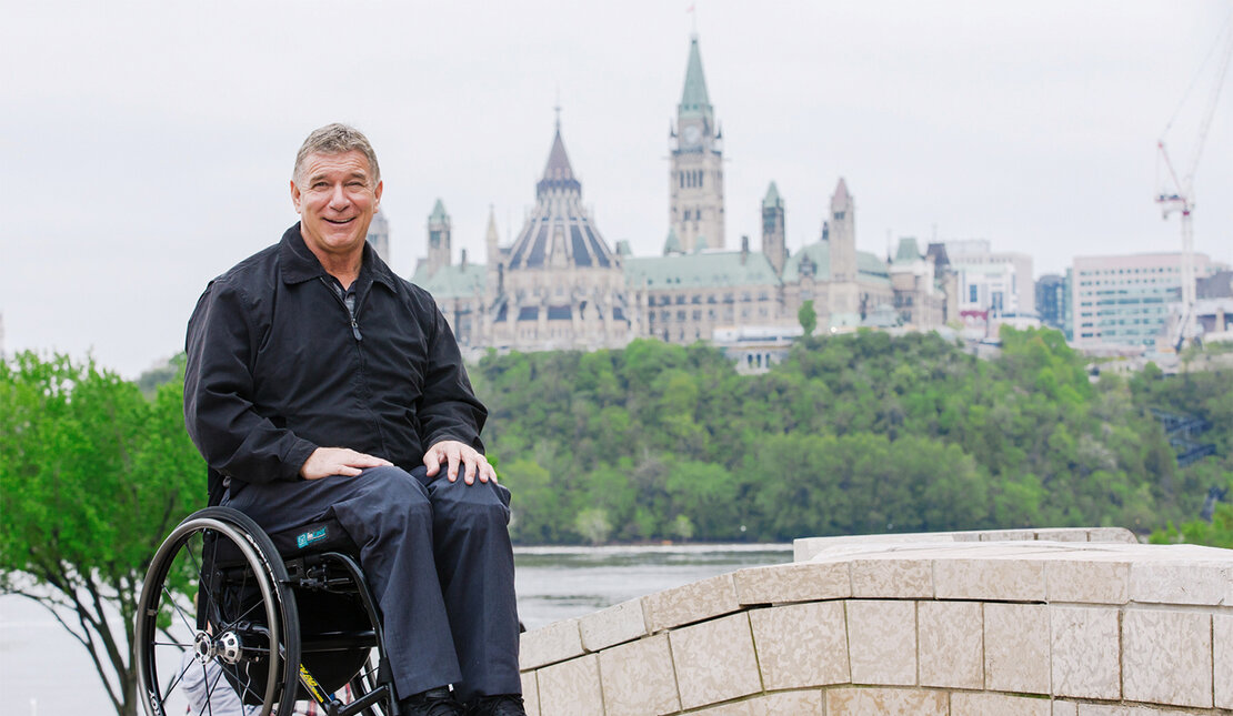 Rick Hansen in front of Parliament building