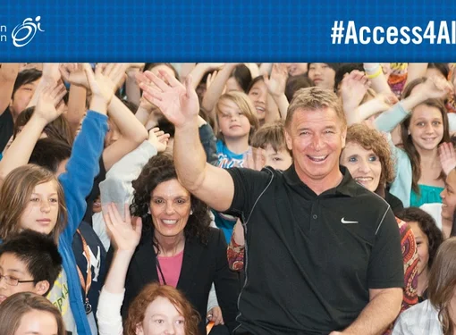 Rick waves with crowd of supporters behind him