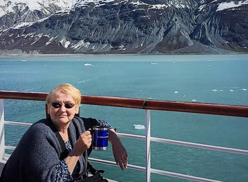 Photo of Margaret Saloustros with water and mountains in the background