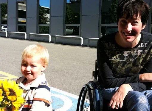 Young boy holding sunflowers with RHF Ambassador, Teri Thorson