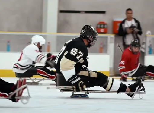 People with disabilities playing a game of ice hockey