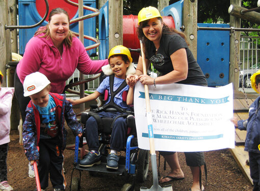 Teachers and students in an accessible playground