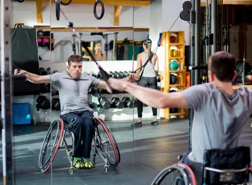 Joel Dembe vigorously exercises at a gym
