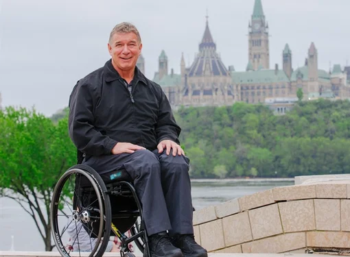 Rick Hansen in front of Parliament building