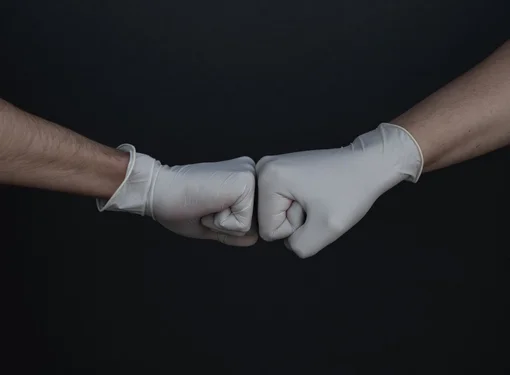 two fists wearing medical gloves