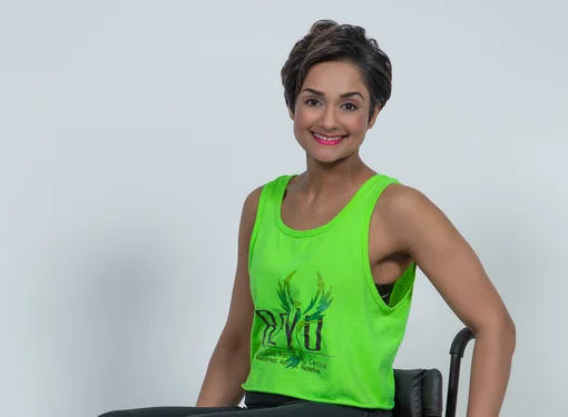 Bean Gill wearing bright tank top, smiling 