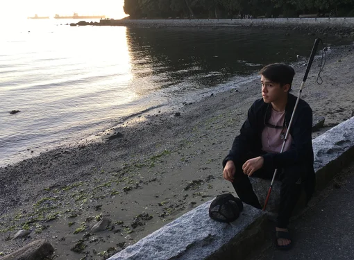 Ben at beach with cane at sunset