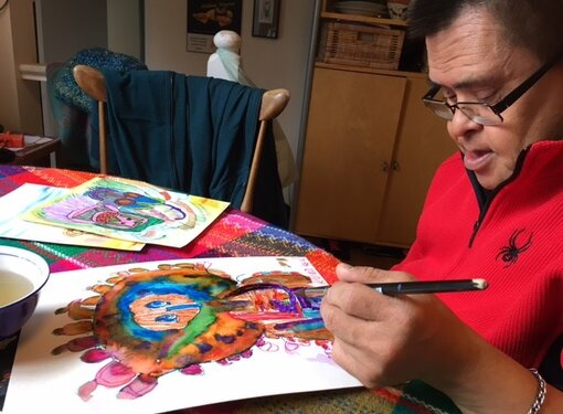 Daryl works on a colorful piece of artwork