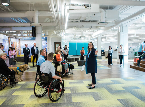 Group of people of different abilities in an accessible common area of a building.