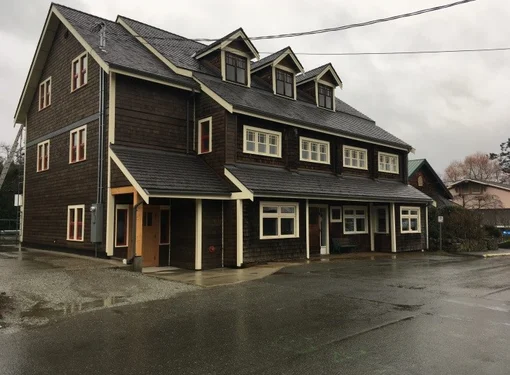 The Salt Spring and Southern Gulf Islands Community Services Society (SSICS) McPhillips Building. It is a large brown building with three peak windows on top.