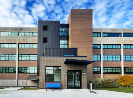 Canada Post Head Office Building B. A large building made out of brick with a blue bench in front.