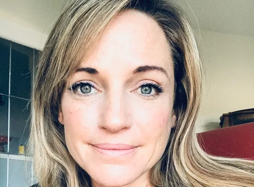 Camille Farrag who has long blonde hair, blue eyes and is wearing a black long sleeve shirt.