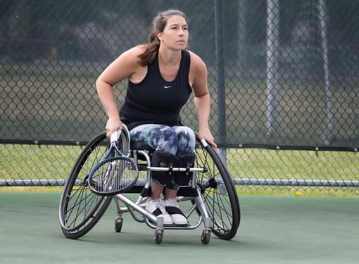 Anne-Marie Dolinar playing wheelchair tennis.
