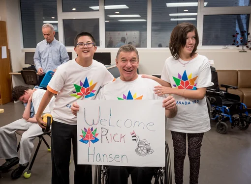 Rick Hansen and students at a school which received a Canada 150 Signature initiative Barrier buster grant