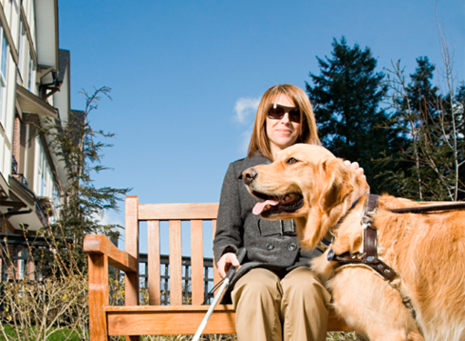 Person with vision loss in built environment with service dog