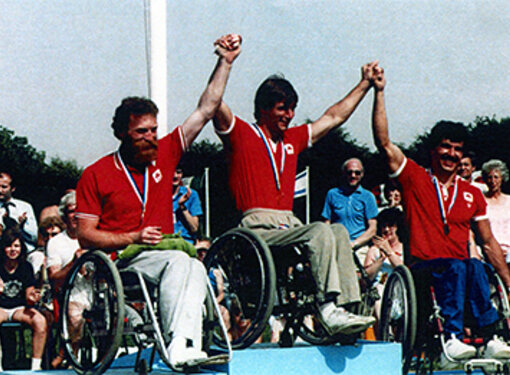 Rick Hansen and team celebrates with crowds of people