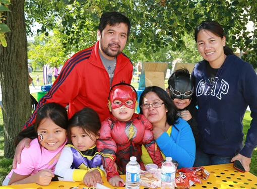 Family at school costume party in built environment