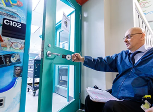 Person with disabilities opening door in built environment