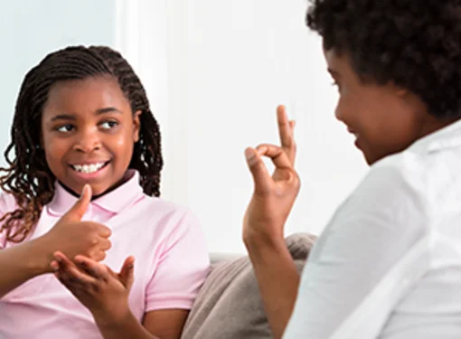 Person with disability hearing loss signing 