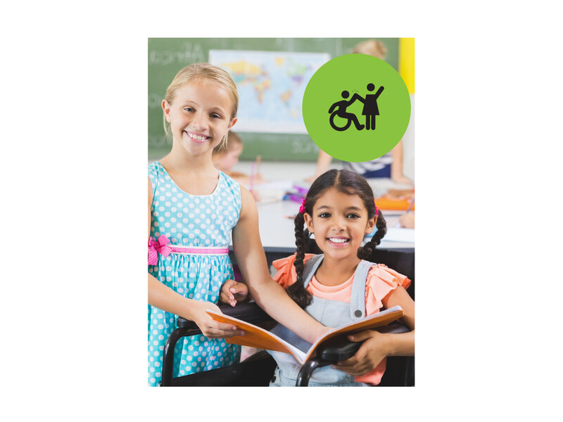 One girl that is standing and one girl that is in a wheelchair, both holding a book together and smiling. Small green circle icon with graphic of person in a wheelchair high-fiving a person that is standing.
