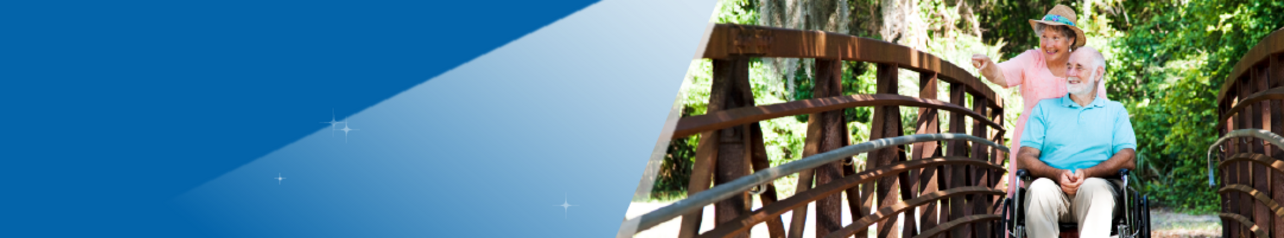 elderly couple using wheelchair cross bridge outdoors, blue background