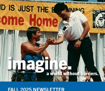A man in a wheelchair shakes hands with another person standing on a stage in front of a yellow banner that reads “JUST THE BEGINNING”. Large white text on the right says “imagine a world without barriers.” A blue footer at the bottom displays “FALL 2025 NEWSLETTER.”