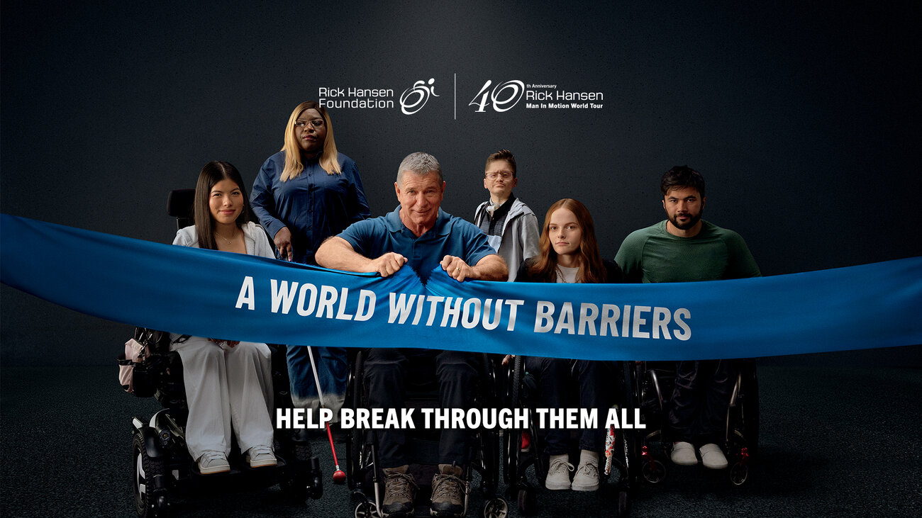 Six people with visible disabilities are ripping a banner reading “A World Without Barriers,” alongside a call to help break through barriers and donate.