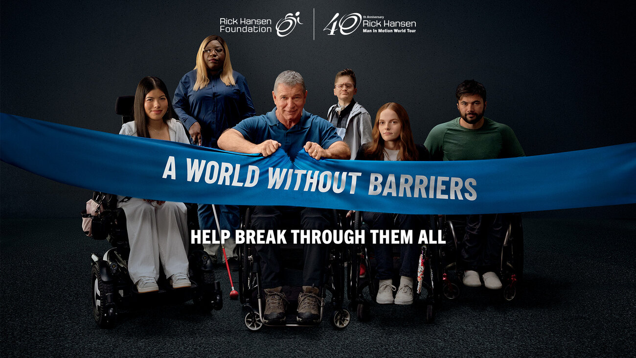 Six people with visible disabilities are ripping a banner that reads “A World Without Barriers,” alongside a call to help break through barriers and donate.