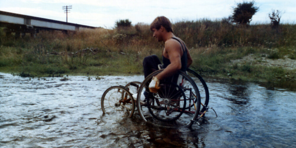 Rick Hansen wheeling through New Zealand with water flooding and strong head winds.