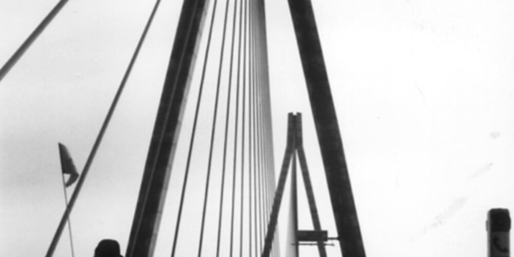 Rick Hansen wheeling over a suspension bridge in Guldborg, Denmark, during August of 1985.