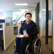 Man using wheelchair holding paperwork