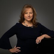 Woman wearing black, smiling