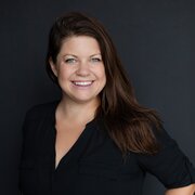 Headshot, woman in black blouse, smiling