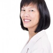 smiling woman with short hair in a doctor's coat