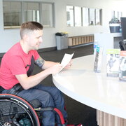 wheelchair user at a desk, smiling
